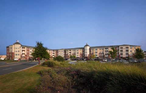 A row of apartment buildings with a clear blue sky above.