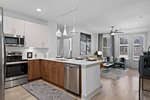 A modern kitchen with wooden cabinets and stainless steel appliances.