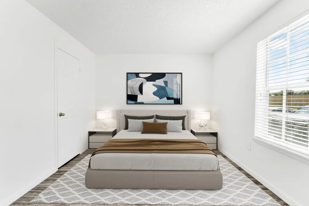 A bedroom with a large bed and a painting above it.