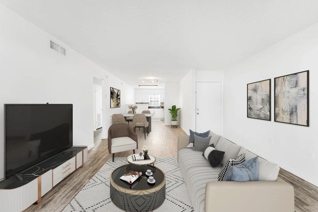 A living room with a television, couch, and coffee table.