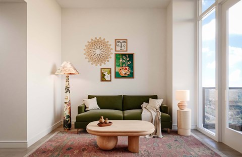 A living room with a green couch and a wooden coffee table.