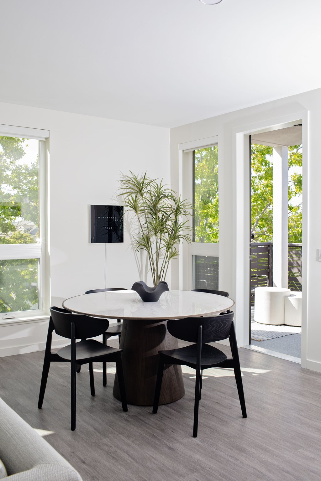 A modern dining room with a round table and chairs.