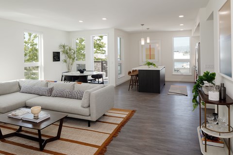 A modern living room with a white couch and a coffee table.