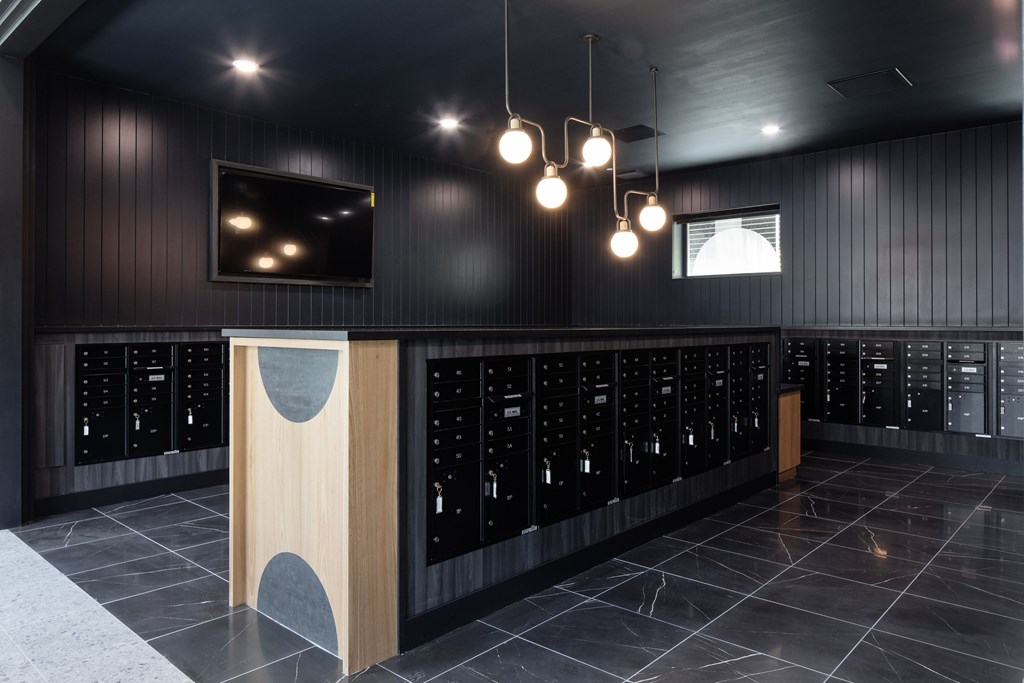 A modern bar with a wooden counter and black cabinets.