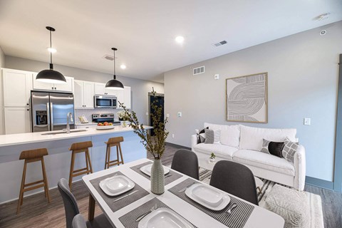 A modern dining room with a table set for four.