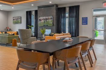 A conference room with a long table and chairs.