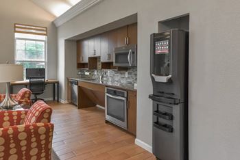 A modern kitchen with a refrigerator on the right side.
