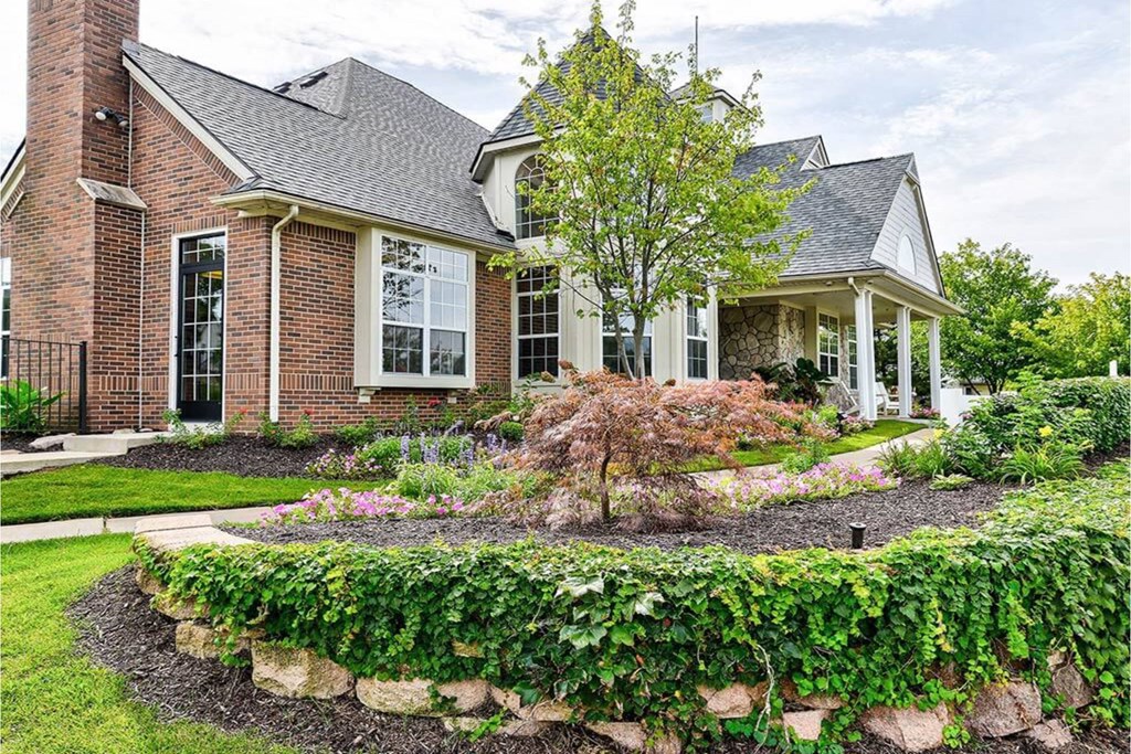 A house with a white porch and a brick chimney.