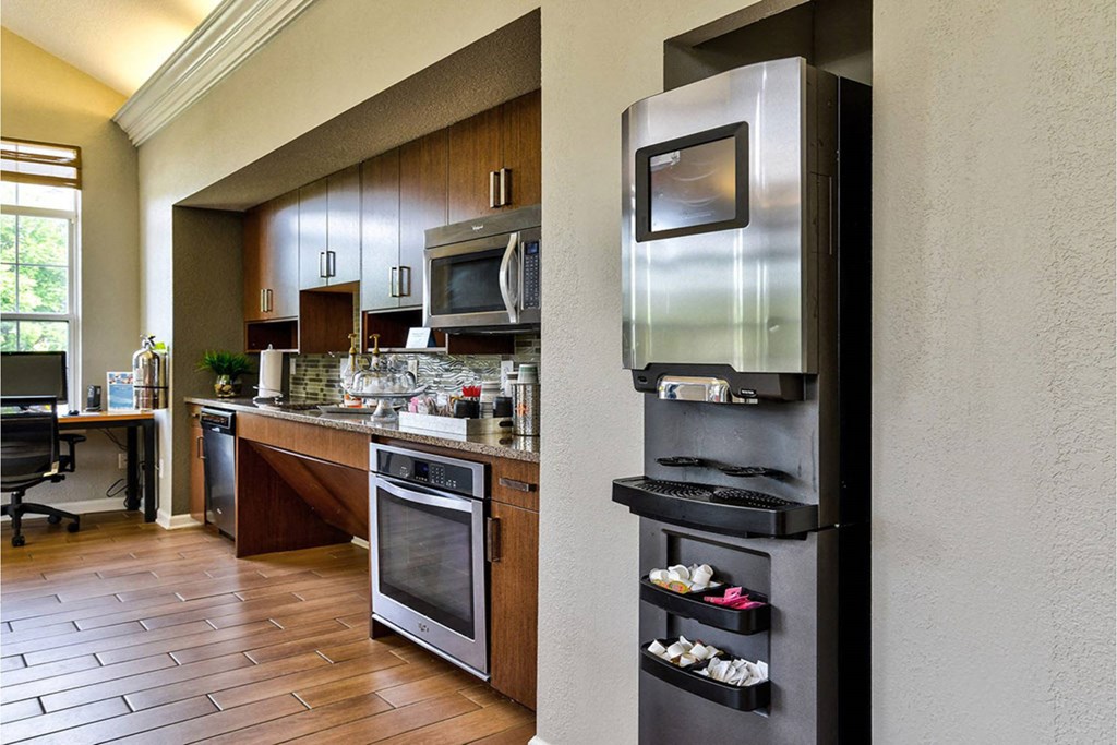 A modern kitchen with a microwave oven built into a cabinet.