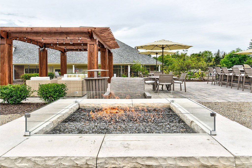 A fire pit sits in the middle of a patio area.