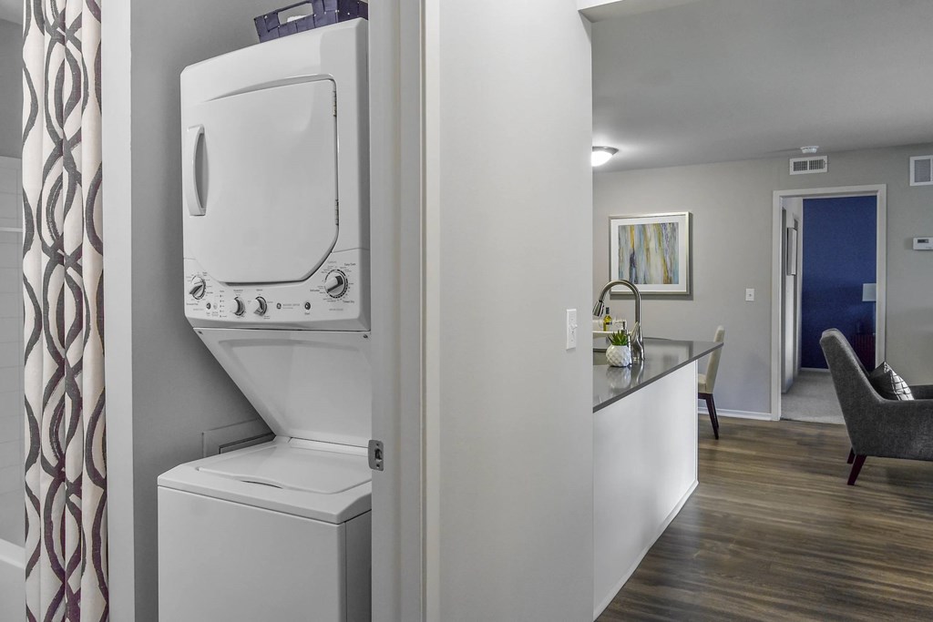 A white washing machine and dryer in a laundry room.