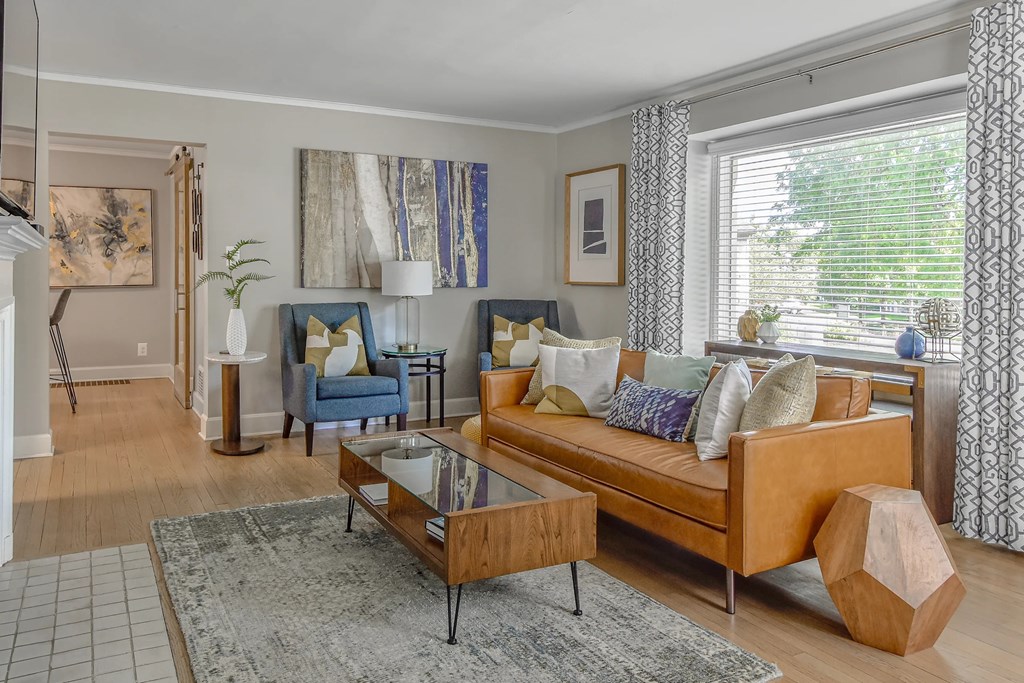 A living room with a blue couch and a coffee table.