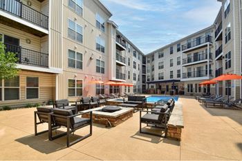A sunny day at the poolside of a residential building.