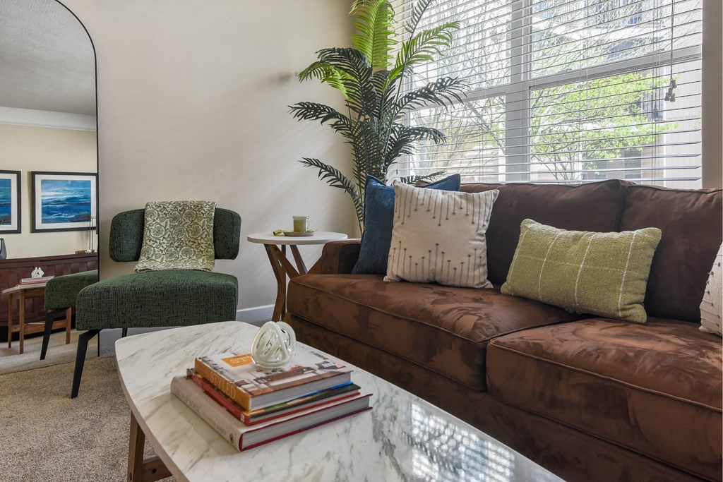 Cozy living room with brown couch at Kenyon Square Apartments in Polaris, Ohio