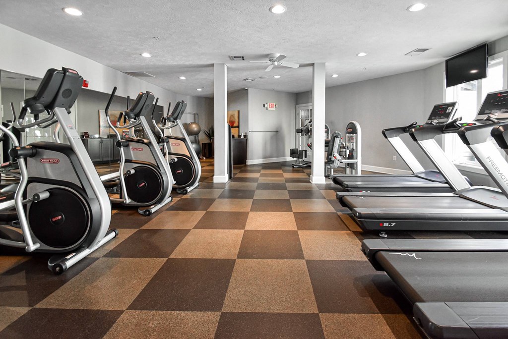 A gym with treadmills and exercise bikes.