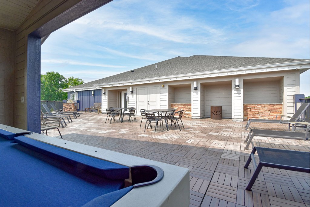 A pool with a view of a backyard with a patio and a house.