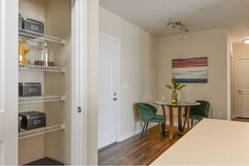 A room with a dining table and chairs.