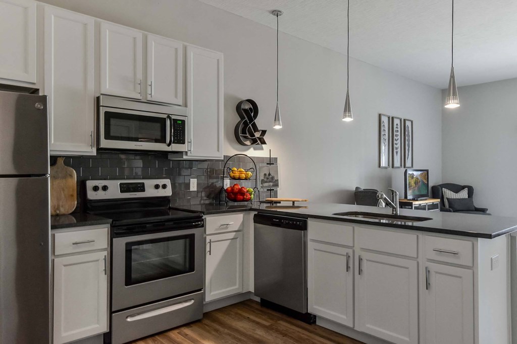 A kitchen with white cabinets and stainless steel appliances.