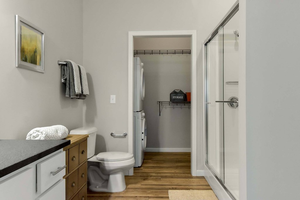 A bathroom with a toilet, sink, and shower.