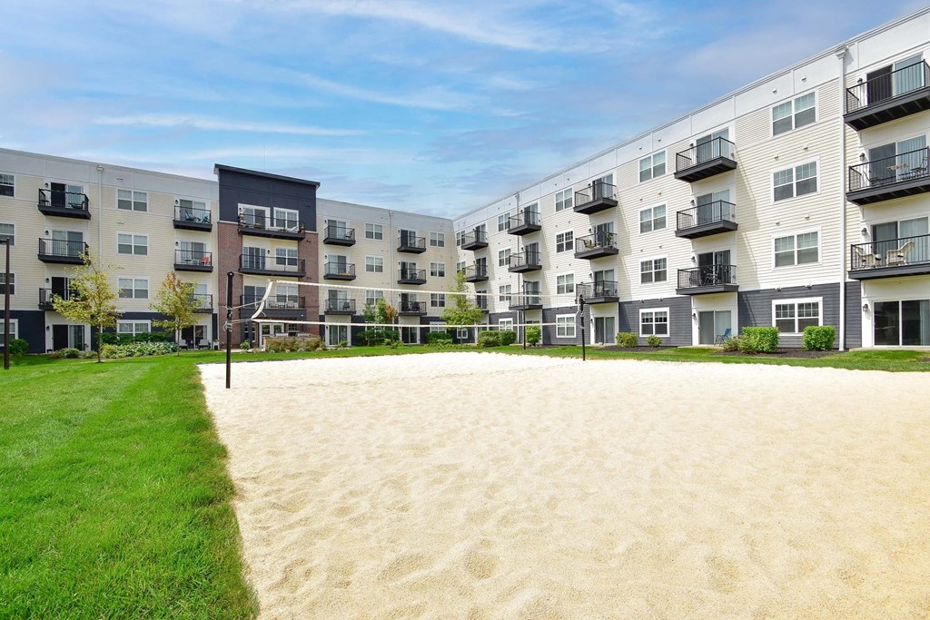 A sandy area in front of apartment buildings.