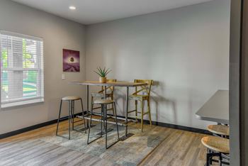 A dining area with a table and chairs.