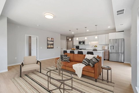 A modern living room with a brown sofa and a coffee table.