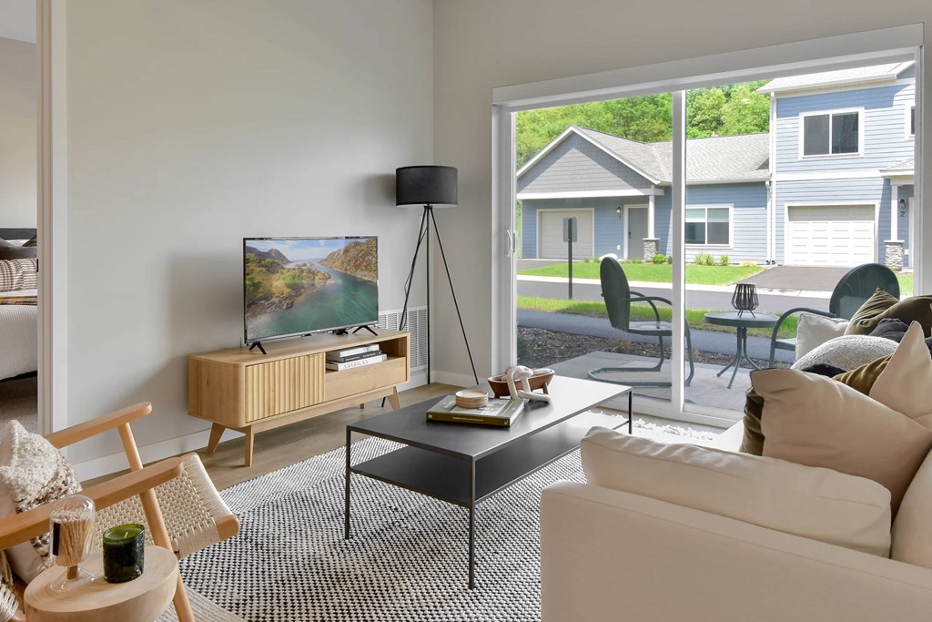 Living room with a patio view at The Lodge at Overland new apartments in Rochester, MN.