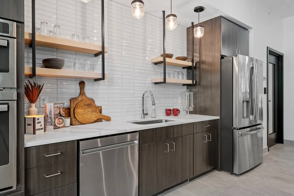 A modern kitchen with stainless steel appliances and wooden accents.