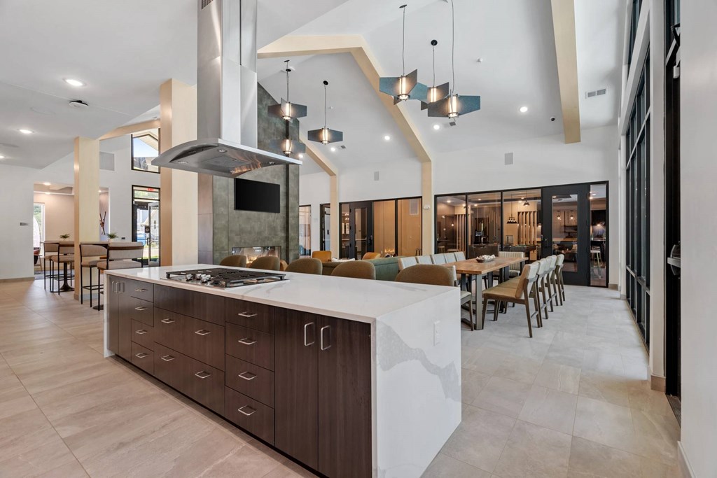 A modern kitchen with a large island and a range hood.