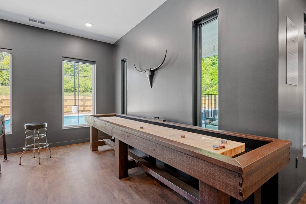 A room with a pool table and a chair.
