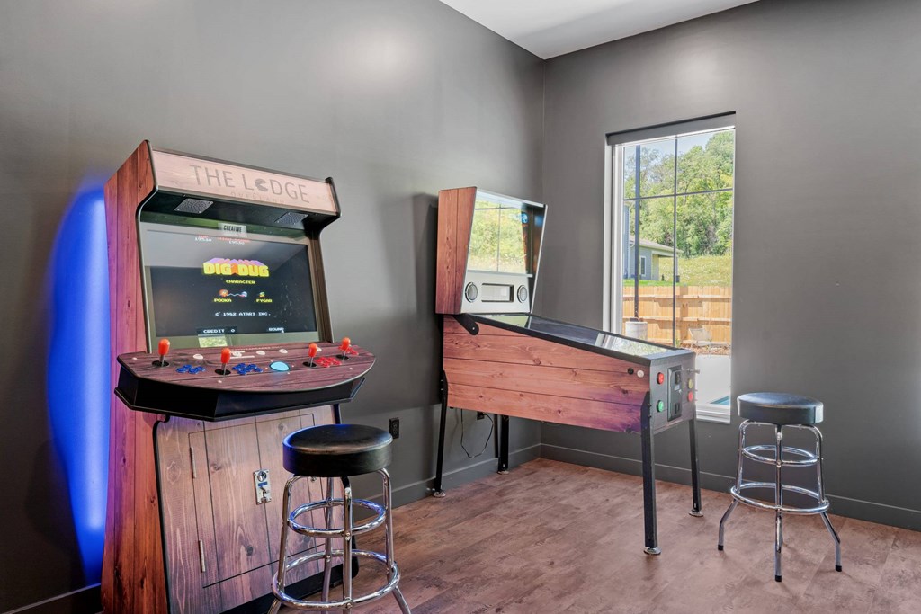 A room with a bar and a gaming console.