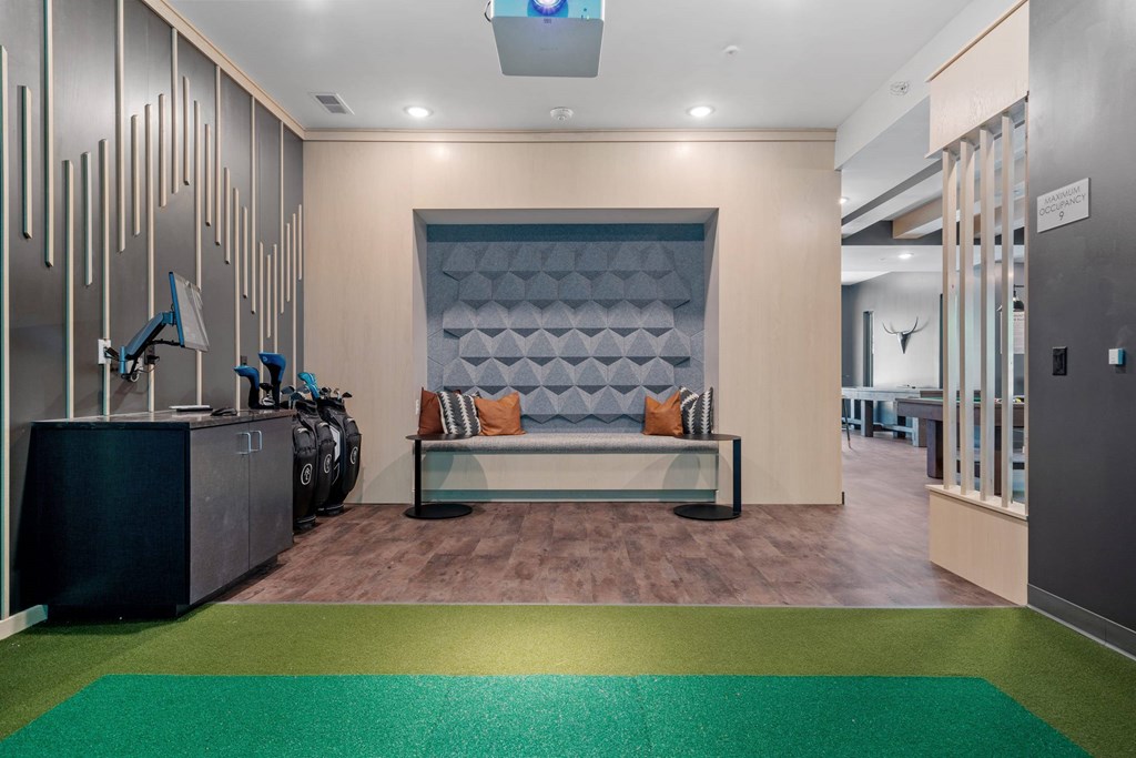 A modern waiting room with a bench and luggage.