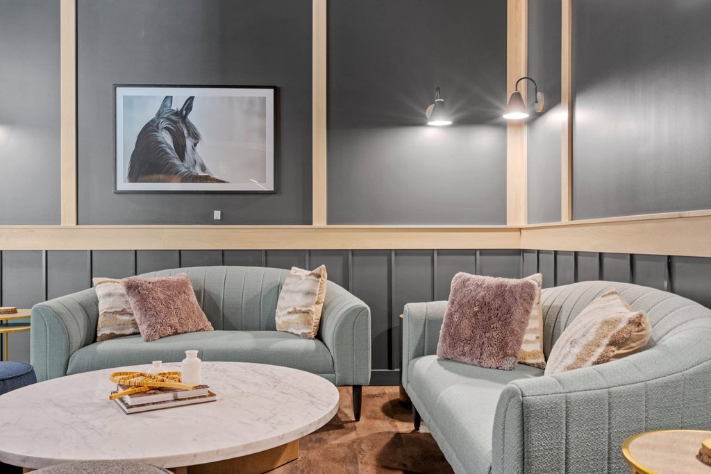 A living room with two grey couches and a coffee table.