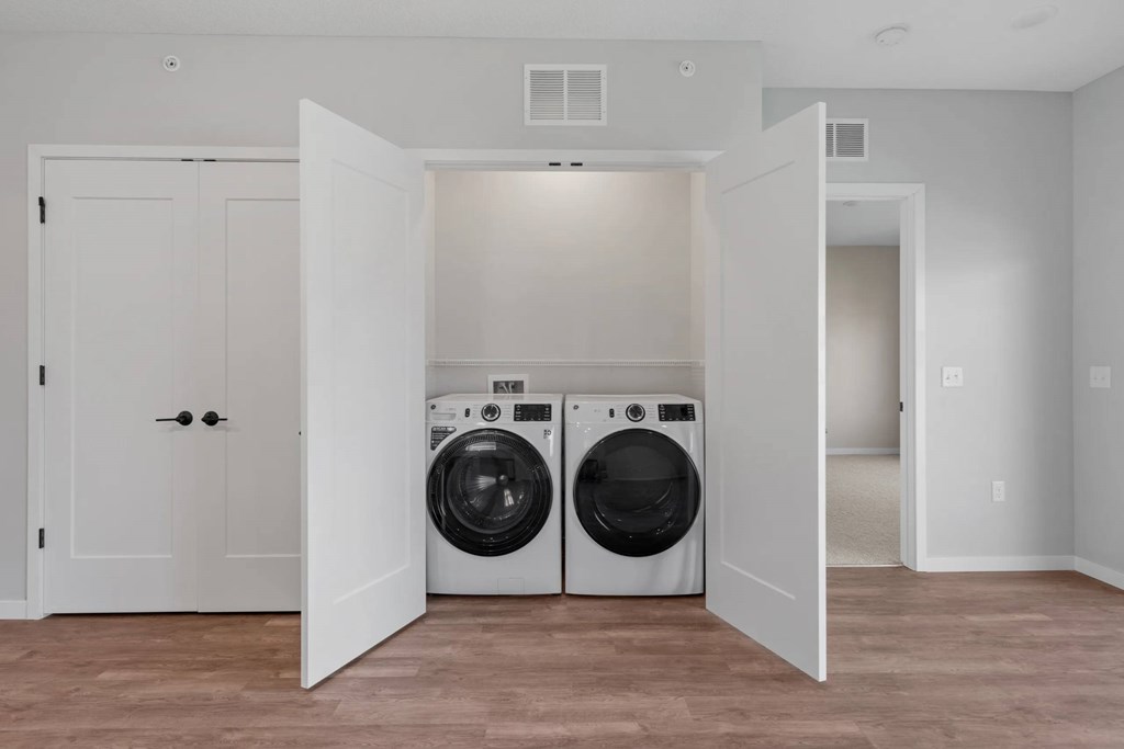 A laundry room with a washer and dryer in it.