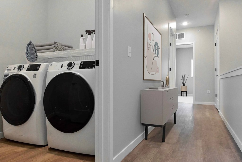 A laundry room with two front loading washing machines.