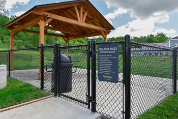 A sign at the entrance of a dog park lists the rules.