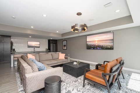 A modern living room with a large couch and a television.