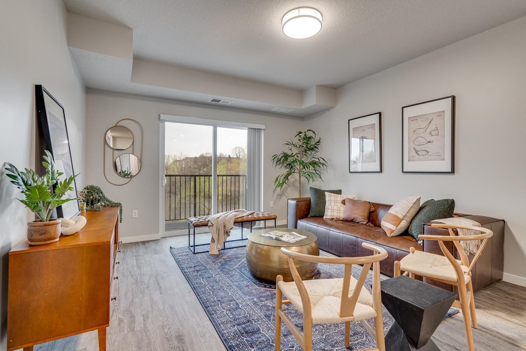A living room with a couch, chairs, and a coffee table.