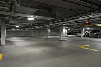 A parking garage with a yellow arrow on the ground.