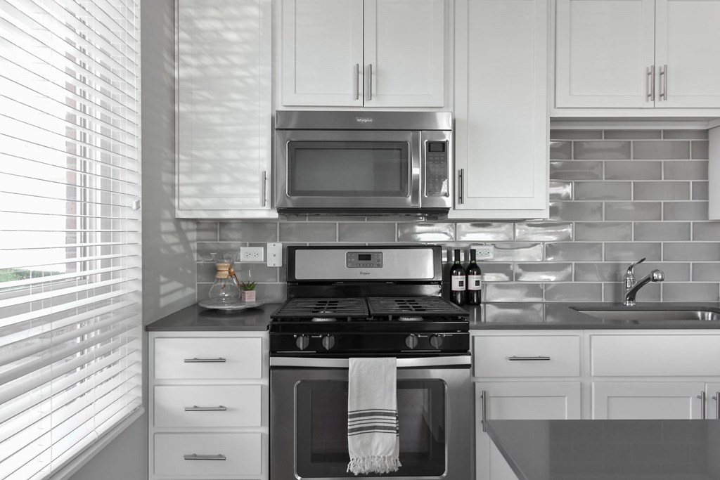 Modern kitchen with white cabinets at Park 205 Park Ridge Apartments