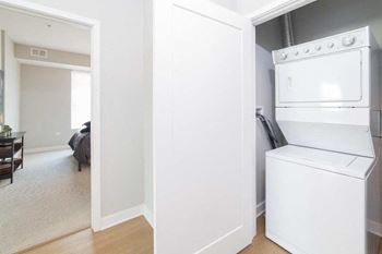 A white washing machine is in a small room.