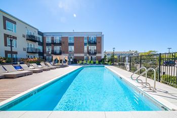 Pool with lounge chairs at Park 205 luxury apartments in Park Ridge, IL