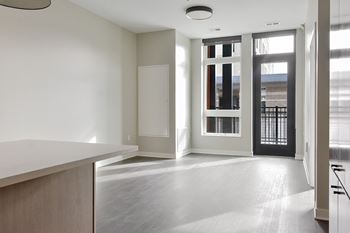 A spacious room with a white counter and a black door.