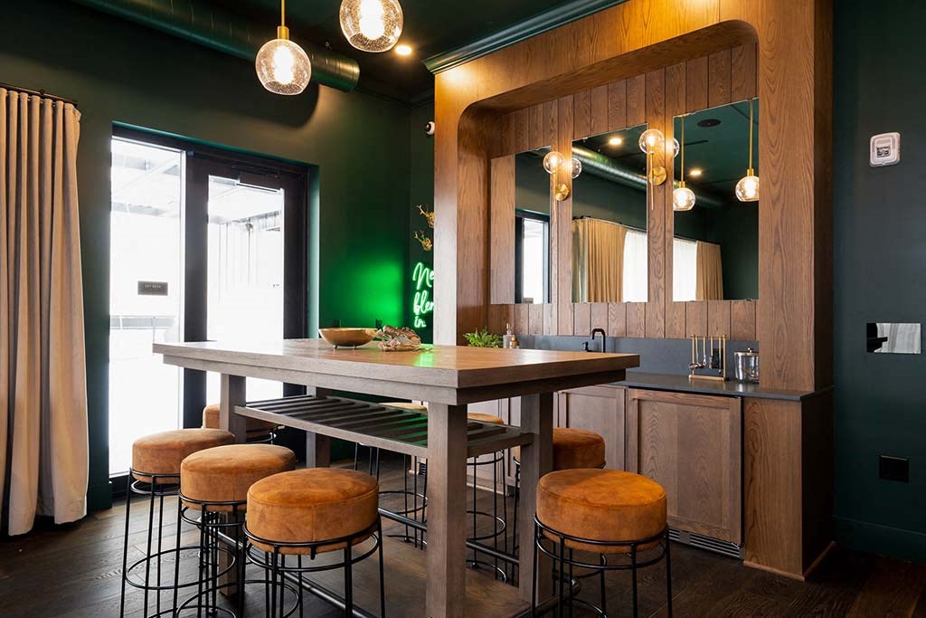 A kitchen with a table and stools.