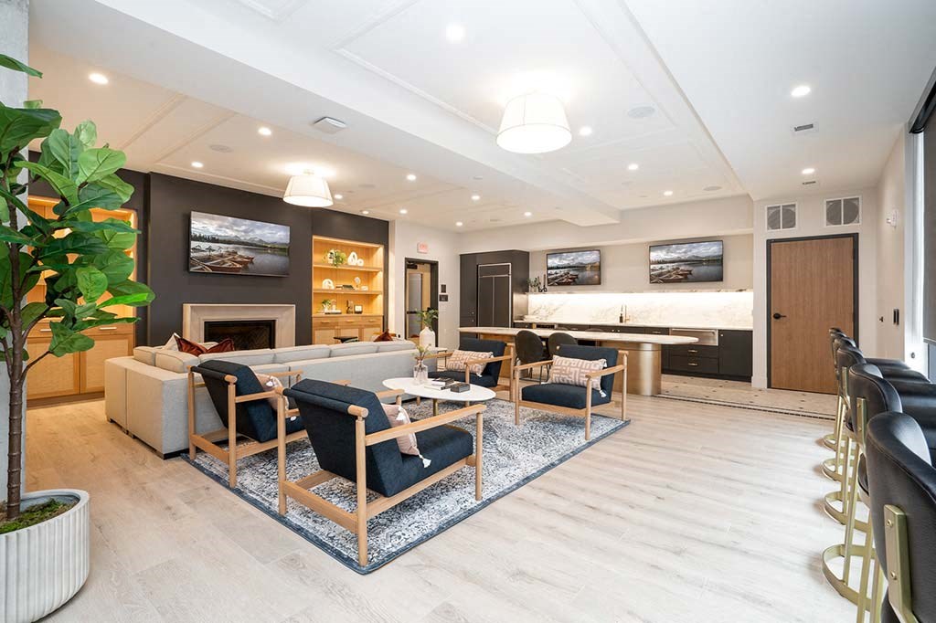 A living room with a fireplace and a large painting above it.