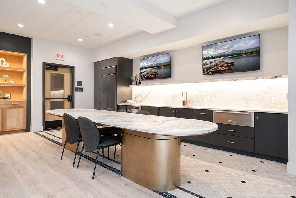 A modern kitchen with a dining table and chairs.