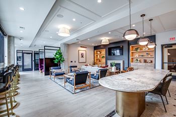 A large, round table is surrounded by chairs in a spacious room.