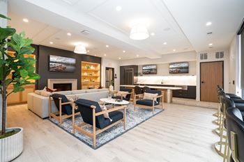 A living room with a fireplace and a large painting above it.