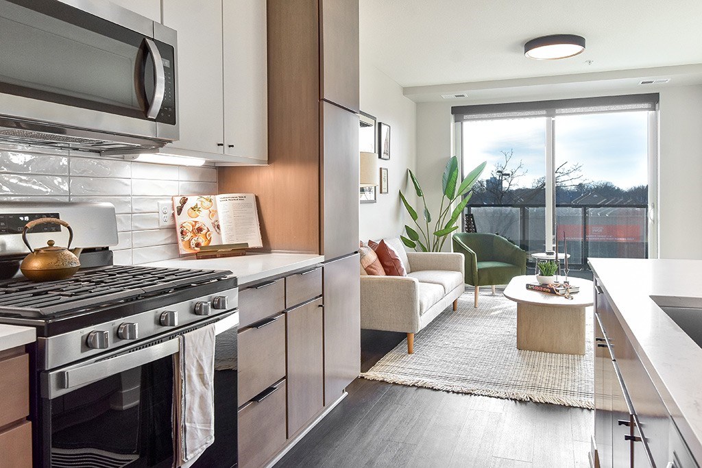 A modern kitchen with a black stove top oven and a white refrigerator.