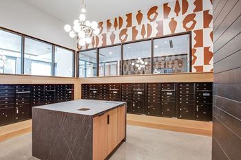 A modern kitchen with a wooden island and black cabinets.